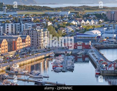 The landscape of the harbor in the city of Bodo on a summer day. A small port in an urban town with boats, buildings, and streets. Aerial view of a Stock Photo