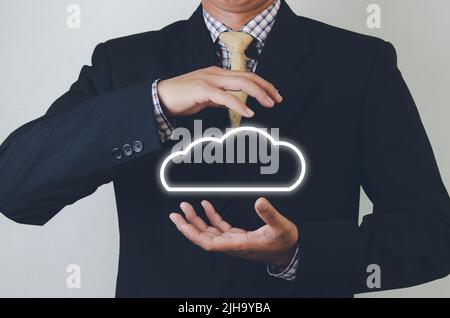 business man holding cloud computer network icon and data connection icon in hand cloud and concept technology. Stock Photo