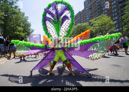 Toronto, Canada. 16th July, 2022. A dressed-up girl poses for photos with her float during the junior parade of the 2022 Toronto Caribbean Carnival in Toronto, Canada, on July 16, 2022. The annual event was held here on Saturday with about 2,000 young people displaying their elaborate costumes. Credit: Zou Zheng/Xinhua/Alamy Live News Stock Photo