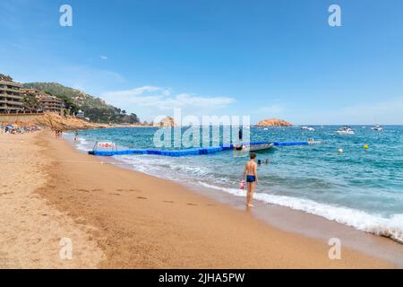 The sandy Platja Gran beach at the resort town of Tossa de Mar, Spain, on the Costa Brava coast of the Mediterranean Sea. Stock Photo