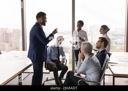 Young executive, project leader meeting with managers, speaking Stock Photo