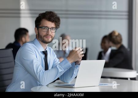 Confident handsome young professional man portrait at laptop Stock Photo