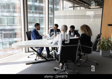 Millennial diverse different aged business team meeting in modern office Stock Photo
