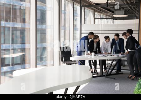 Multiethnic millennial business group of employees brainstorming on project Stock Photo