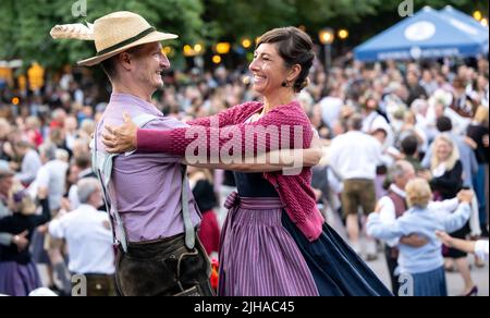 Munich, Germany. 17th July, 2022. Dance teachers Katharina Mayer and Magnus Kaindl dance on stage at the traditional Kocherlball at the Chinese Tower in the English Garden. The Kocherlball goes back to an old Munich tradition. In the 19th century, on beautiful summer Sundays, the servants - the 'Kocherl' - gathered to dance. They came early in the morning because they had to work for their masters afterwards. Credit: Sven Hoppe/dpa/Alamy Live News Stock Photo