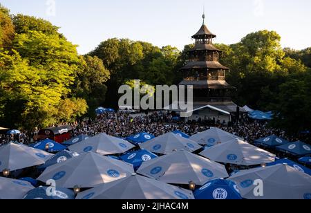 Munich, Germany. 17th July, 2022. Numerous people dance at the traditional Kocherlball at the Chinese Tower in the English Garden. The Kocherlball goes back to an old Munich tradition. In the 19th century, on beautiful summer Sundays, the servants - the 'Kocherl' - gathered to dance. They came early in the morning because they had to work for their masters afterwards. Credit: Sven Hoppe/dpa/Alamy Live News Stock Photo