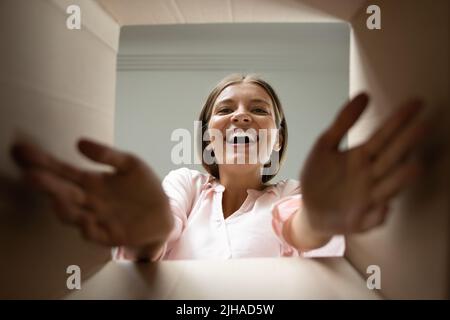 Woman unpack parcel closeup, view from bottom of box Stock Photo