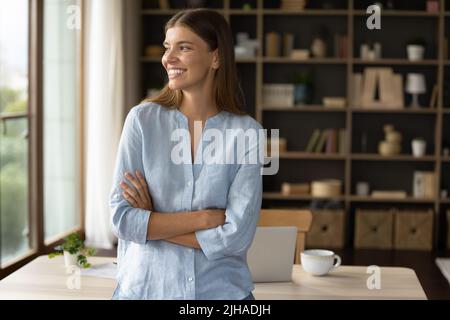 Beautiful woman pose in modern office smile look into distance Stock Photo