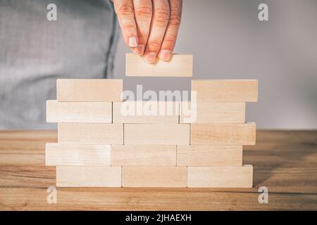 Creating a stable foundation for the company's operations, Business development based on solid foundations Creative concept, Entrepreneur builds a wal Stock Photo