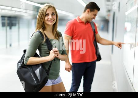 Couple is standing near map and choosing route Stock Photo