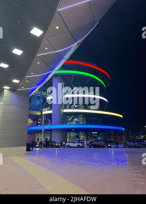 Colorful facade of illuminated Khalifa International Stadium in Doha, Qatar at night Stock Photo