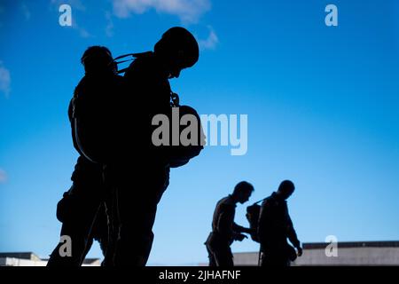 June 24, 2022 - Morocco - U.S. Air Force Airmen from the 435th Contingency Response Squadron and 435th Security Forces Squadron help Moroccan Armed Forces service members before an airborne operation during Exercise AFRICAN LION 22 on June 24, 2022, in Morocco. More than 7,500 participants from 28 nations and NATO train together with a focus on enhancing readiness for U.S. and partner-nation forces. AL22 is a joint all-domain, multi-component, and multinational exercise, employing a full array of mission capabilities with the goal to strengthen interoperability among participants and set the t Stock Photo