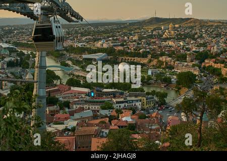 Tbilisi, Georgia sunset Panoramic view from top of fortress of Narikala showing the bridge of peace, Rike Park, Kura River and Holy Trinity Cathedral Stock Photo