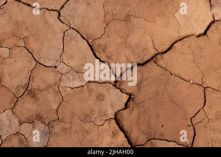 Dry ground in drought conditions with cracks Stock Photo