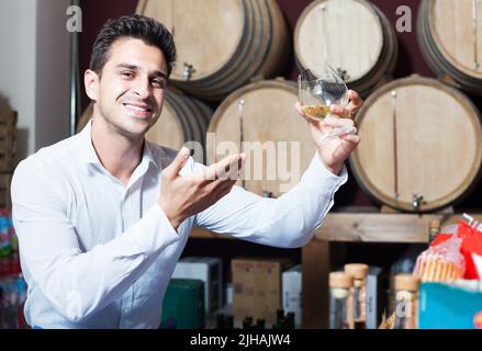 Man tasting wine in store Stock Photo