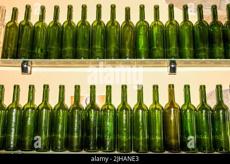 Empty glass bottles on a shelf. Stock Photo