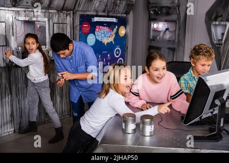 Emotional tween children using computer in quest room shelter Stock ...