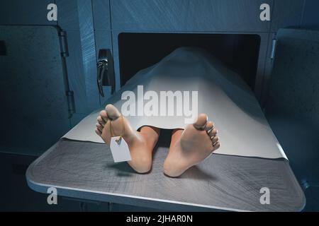The feet of a deceased person stick out from under the sheet in the hospital morgue Stock Photo
