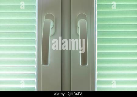double window with closed pleated blinds Stock Photo