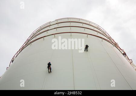 Male worker down height tank shell plate rope ladder access safety ...