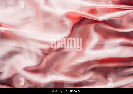 Smooth elegant pink silk or satin texture, abstract background luxury pink fabric with wavy folds Stock Photo