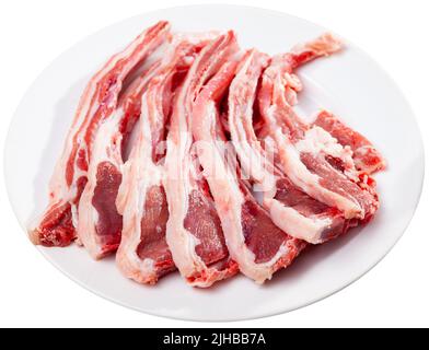 Raw lamb chops on plate Stock Photo