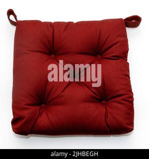 Red textile decorative chair pillow isolated on white background Stock Photo