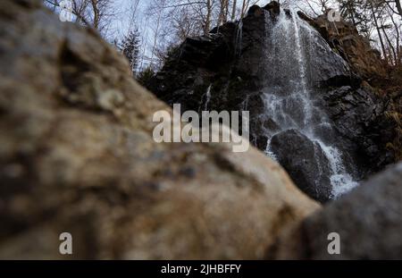 A low shot of water flowing down a rock in Bad Harzburg Germany Stock Photo