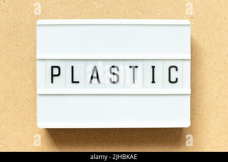 Lightbox with word plastic on wood background Stock Photo
