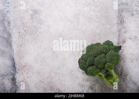 Broccolini. Fresh bunch of broccoli sprouts on concrete gray table or background. Healthy food concept. Food crisis concept. Food cooking background. Stock Photo