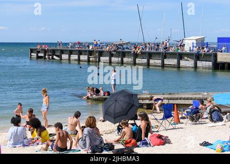 Whitstable, Kent, UK: People enjoy the summer sunshine in Whitstable at the start of a record-breaking heatwave in the UK. Stock Photo