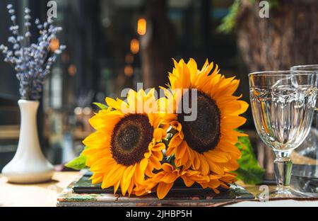Close-up, a bouquet of sunflowers in a cafe on the table. Stock Photo
