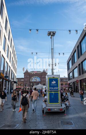 Bonn, Germany - July 16, 2022: Police video surveillance tower is set up in a busy shopping street at Bonn's main train station to provide security. Stock Photo