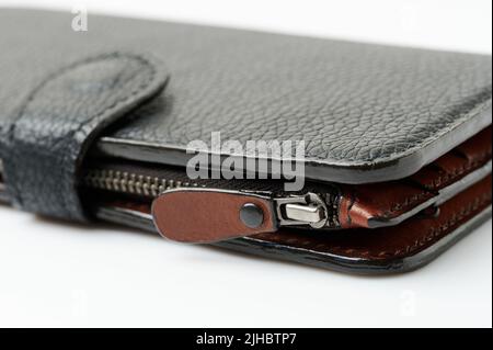 Closed zipper on black leather purse macro close up view Stock Photo