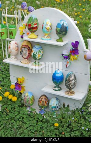 Easter eggs decorated and decorated with colorful ribbons are displayed in the park for the holidays Stock Photo