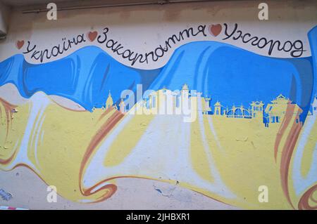 Graffiti painted on a wall in Uzhhorod in an alley on a sunny summer day Stock Photo