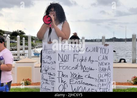 Cocoa, Brevard County, Florida. USA. July 16, 2022. A group held a protest rally in support of woman's rights at a riverfront park in Cocoa Village then walked through the streets to the US1 major intersection to wave signs and shout slogans to passing motorists. Credit: Julian Leek/Alamy Live News Stock Photo