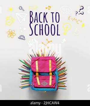 Backpack with stationery and text BACK TO SCHOOL on light background Stock Photo