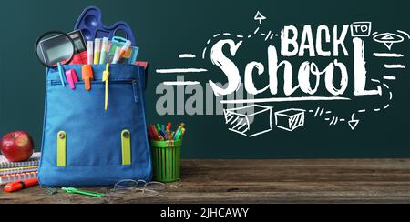 Backpack with stationery and apple on table. Back to school Stock Photo