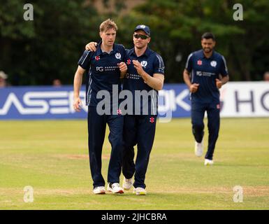 ICC Men's Cricket World Cup League 2 - Scotland v, Nepal. 17th July, 2022. Scotland take on Nepal for the second time in the ICC Div 2 Men's Cricket World Cup League 2 at Titwood, Glasgow. Pic shows: Scotland's Gavin Main is is mobbed by teammates after dismissing NepalÕs Dev Khanal for 10 runs. Credit: Ian Jacobs/Alamy Live News Stock Photo