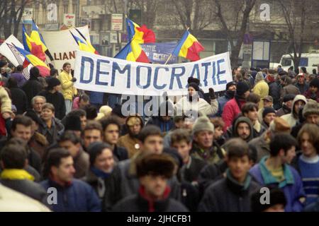 Bucharest, Romania, January 22, 1999. Political march ('Mars pentru Democratie') organized by the Civic Alliance Foundation. Participants holding a large banner displaying the word 'Democracy'. Stock Photo