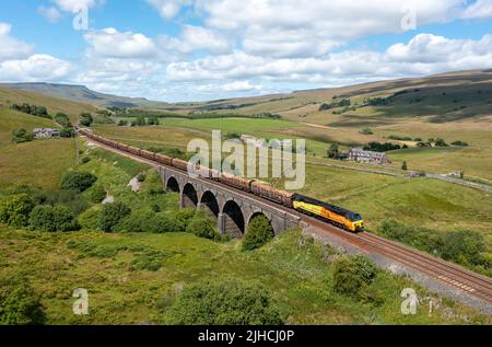 Colas Class 70808 heads the 12.57 Carlisle to Chirk Log Train crossing Lunds Viaduct on the Settle and Carlisle Railway. 13th July 2022 Stock Photo