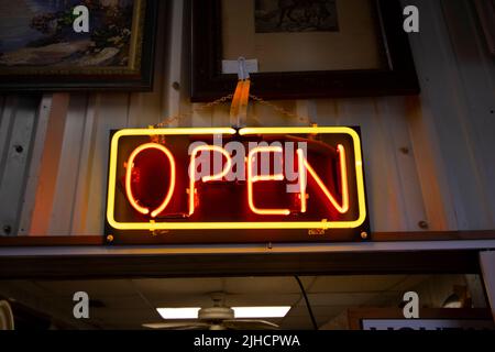 Bright neon Open sign above a vintage store entrance Stock Photo