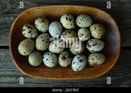 Fresh quail eggs close up on a wooden table small hard boiled eggs rustic top view Stock Photo