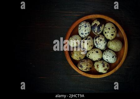 Fresh quail eggs close up on a wooden table small hard boiled eggs rustic top view Stock Photo