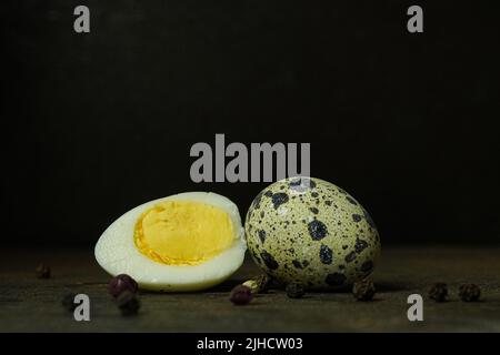 Fresh quail eggs close up on a wooden table small hard boiled eggs rustic top view Stock Photo