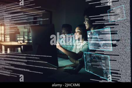 Those who keep at it hold the keys to success. a group of young businesspeople using a computer together during a late night at work. Stock Photo