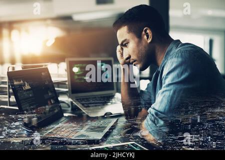 Lifes a game with no reset on the end. a young man suffering from a headache while using a laptop in a modern office. Stock Photo