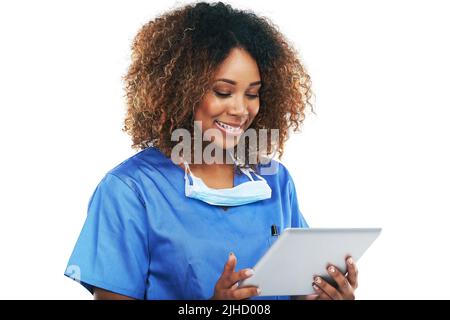 Technology helps advance her healthcare career. Studio shot of an attractive young nurse using a digital tablet against a white background. Stock Photo