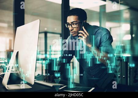One decision away from a better tomorrow. a young man using his cellphone while working on a computer in a modern office. Stock Photo